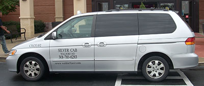 two silver cabs in front of shopping mall